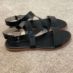 Black leather Cole Haan sandals with woven strap detail